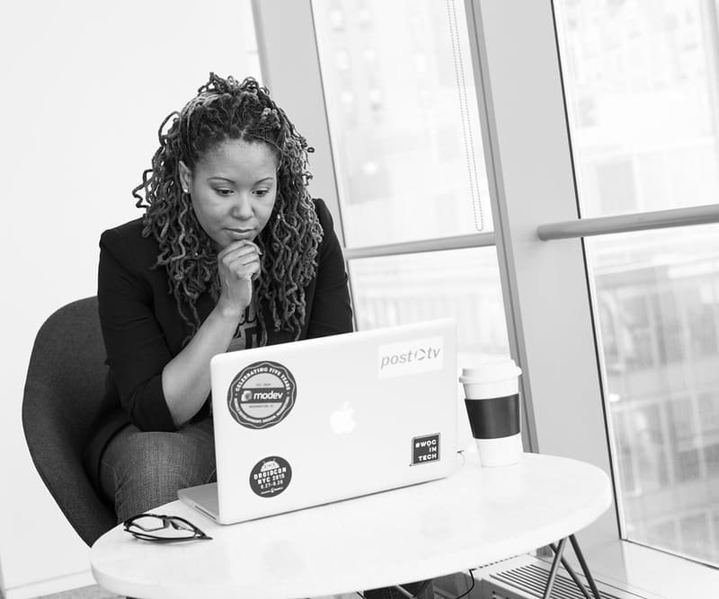 Business owner deep in thought at her laptop